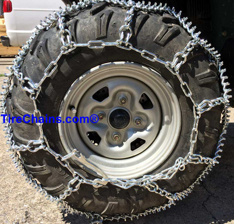 Front view of ATV studded diamond chains installed on tire
